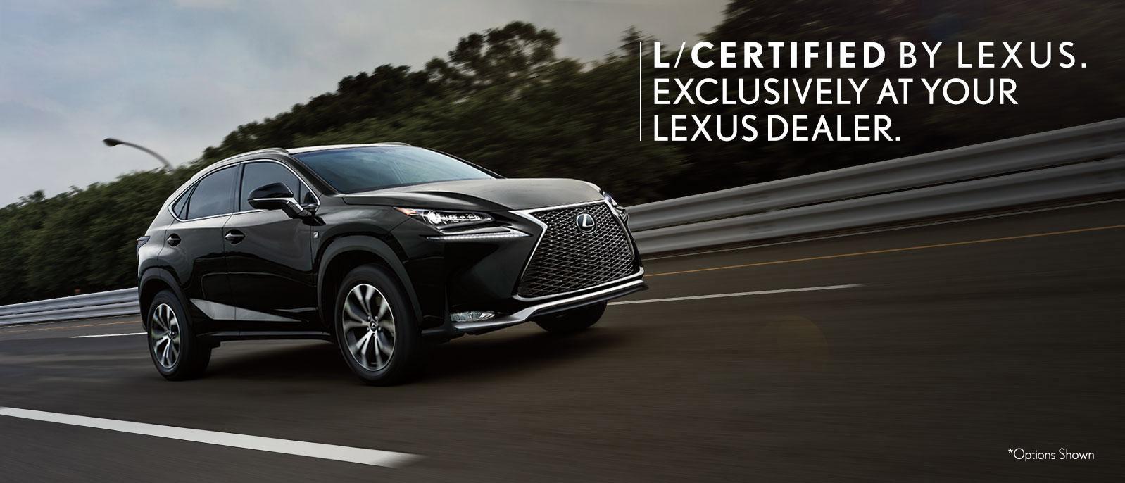 Black Lexus SUV driving down the road Black Lexus SUV driving down the road