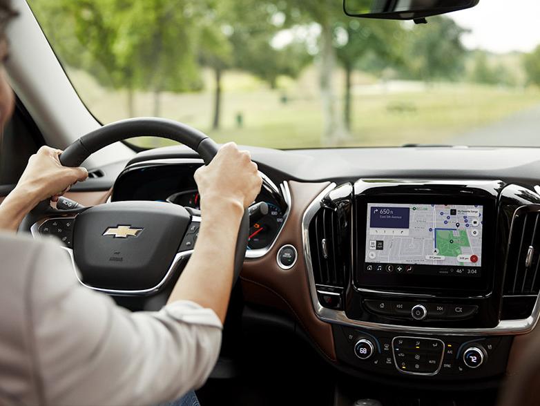 Woman driving chevy with navigation on screen Woman driving chevy with navigation on screen