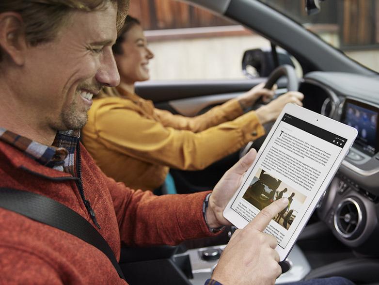 Man with tablet and woman driving Man with tablet and woman driving