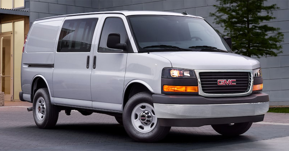 2025 GMC Savana Cargo Van parked in front of a building