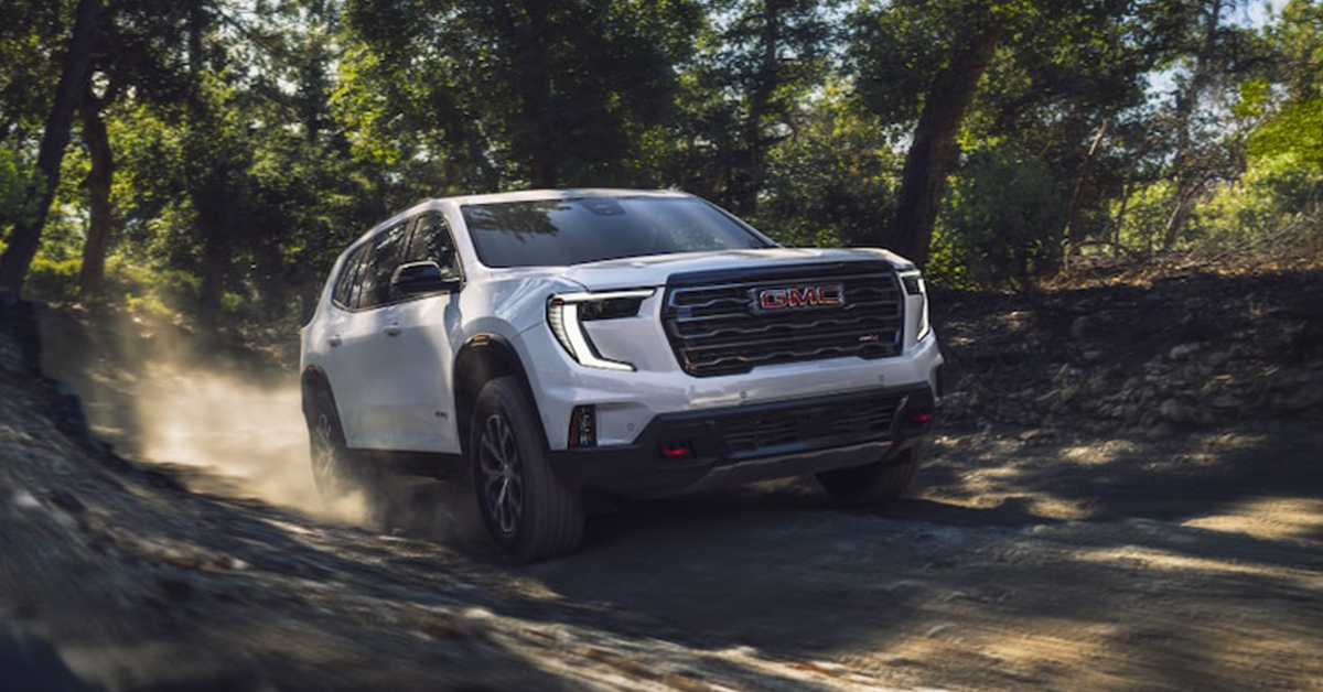 2025 GMC Acadia Driving through a forest