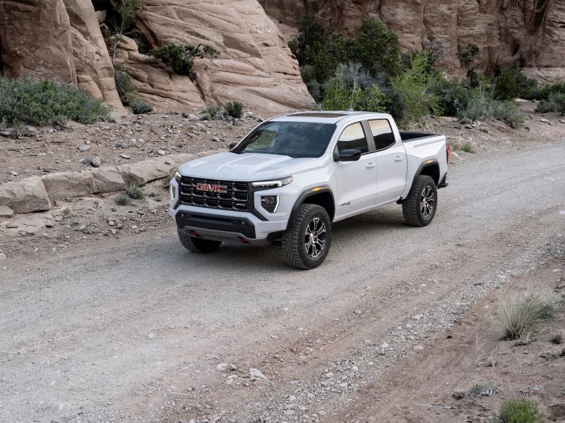 white 2023 GMC Canyon AT4X on a dirt road