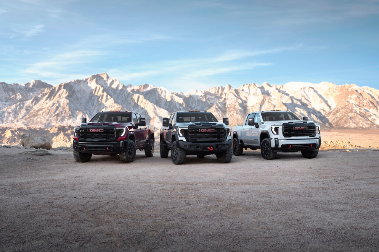 Group shot of the 2024 GMC Sierra 2500HD premium off-road lineup. From left to right: Sierra 2500HD AT4X, Sierra 2500HD AT4X AEV Edition and Sierra 2500HD AT4.