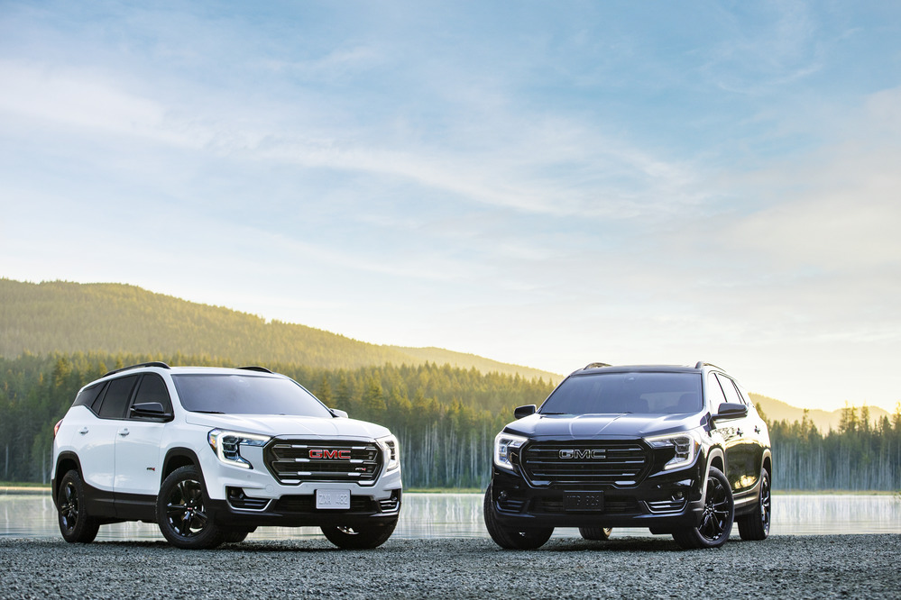 2022 GMC Terrain AT4 in Summit White and 2022 GMC Terrain Elevation in Ebony Twilight Metallic.