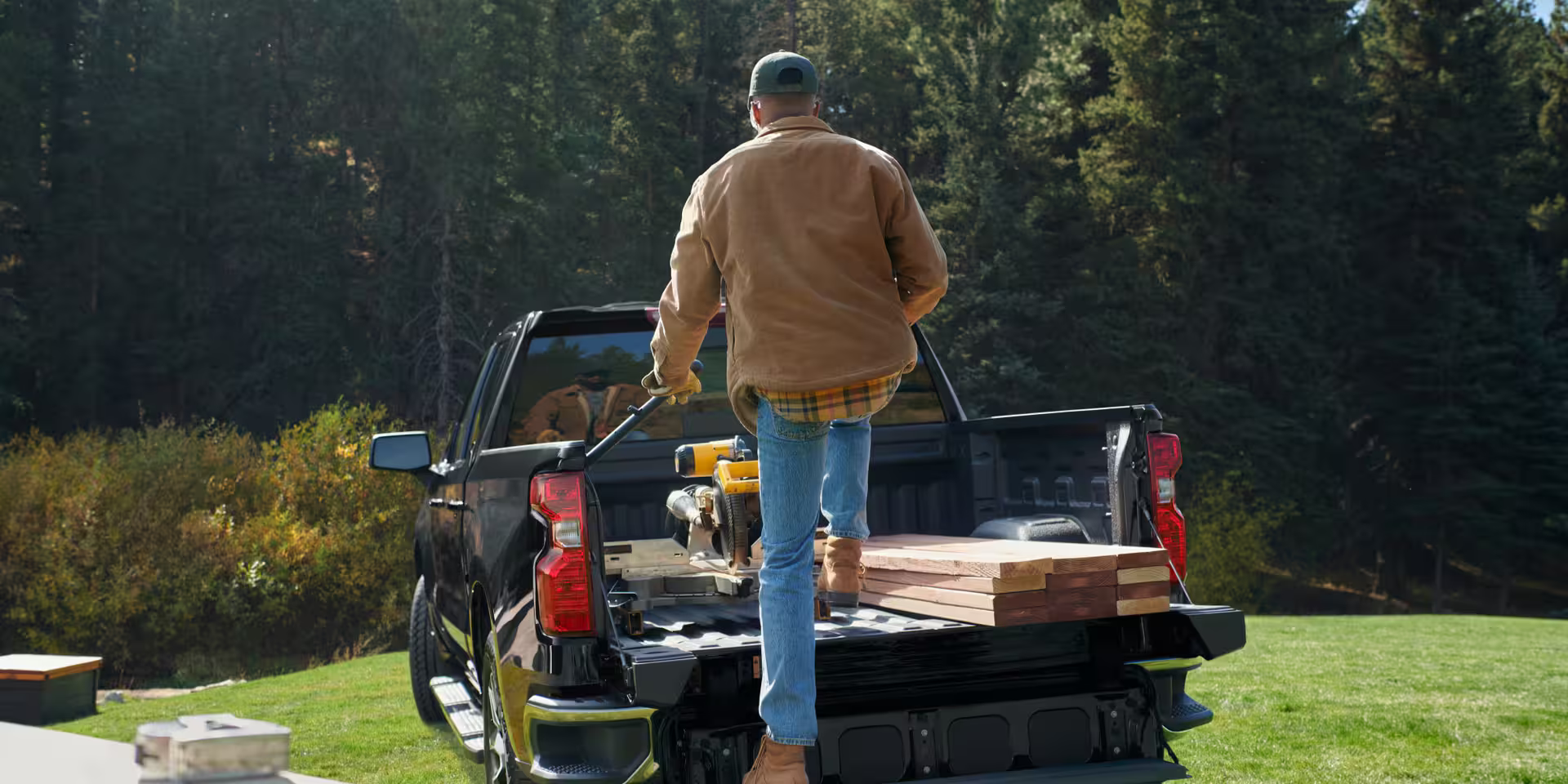 A man working in the bed of the 2025 Chevrolet Silverado 1500