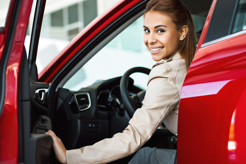 Woman getting into a used car