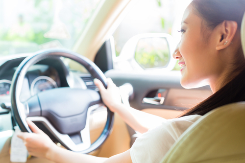 Woman driving pre-owned car