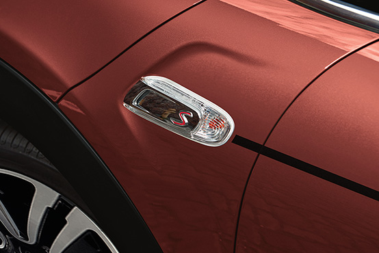 A close-up of the MINI COOPER HARDTOP CORAL RED EDITION’s Coral Red Metallic exterior paint and Black Pinstripe.