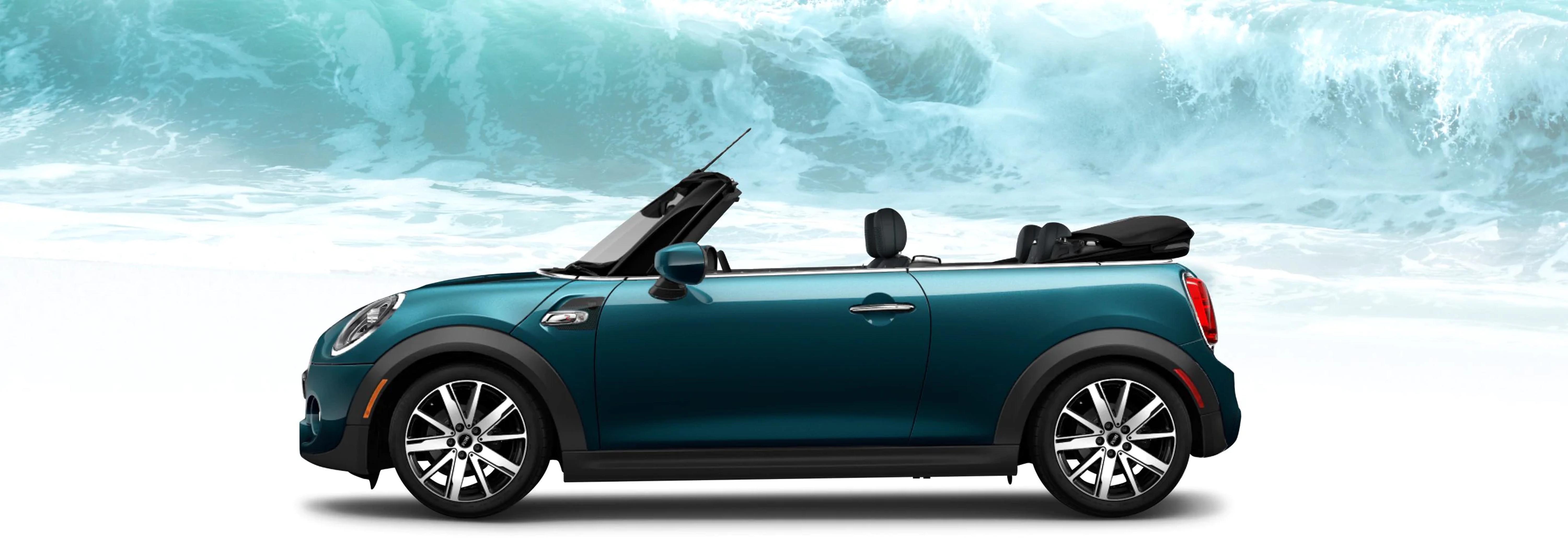 The MINI Cooper S Convertible Sidewalk Edition in front of a large ocean wave.