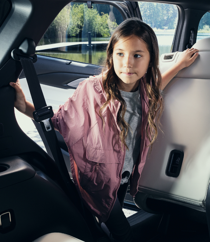 Little girl admiring Mazda CX-9