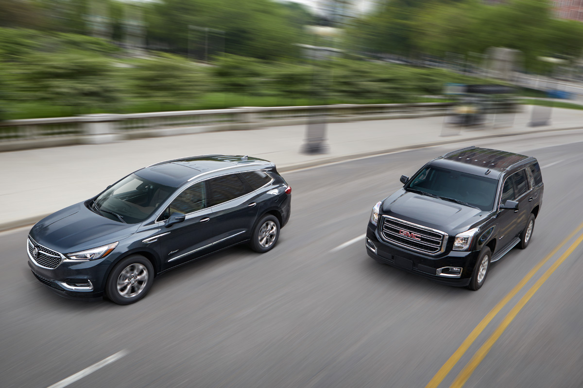 Buick and GMC models on city street.