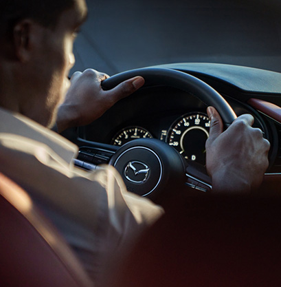 A man driving a Mazda3 Hatchback
