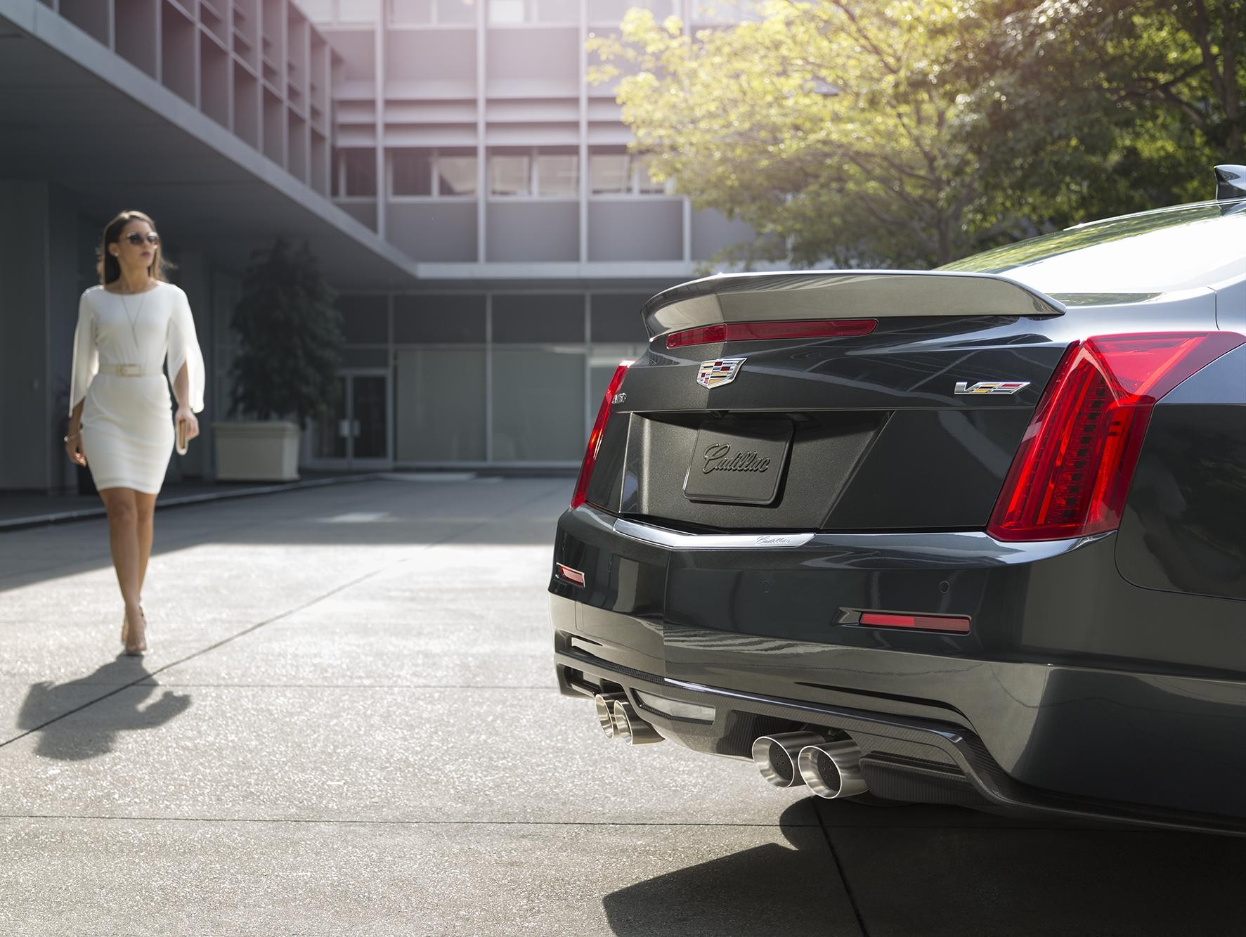 Woman walking toward back of Cadillac