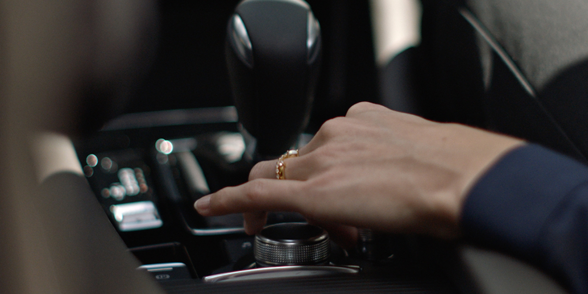 A close up of a hand holding a remote control