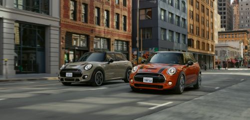 Two MINI’s driving down the street
