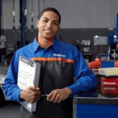 Service tech standing next to desk and smiling Service tech standing next to desk and smiling