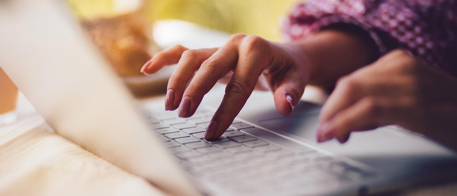 Closeup of hands on computer
