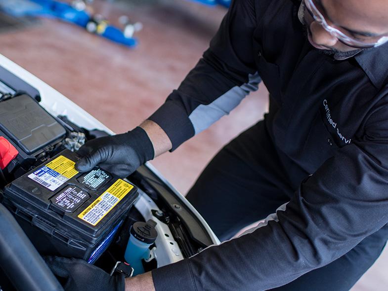 Service technician changing vehicle battery at our Chevy Truck Dealers Near Me Location Service technician changing vehicle battery at our Chevy Truck Dealers Near Me Location