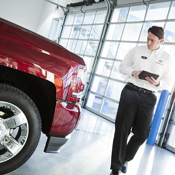 Service technician inspecting vehicle