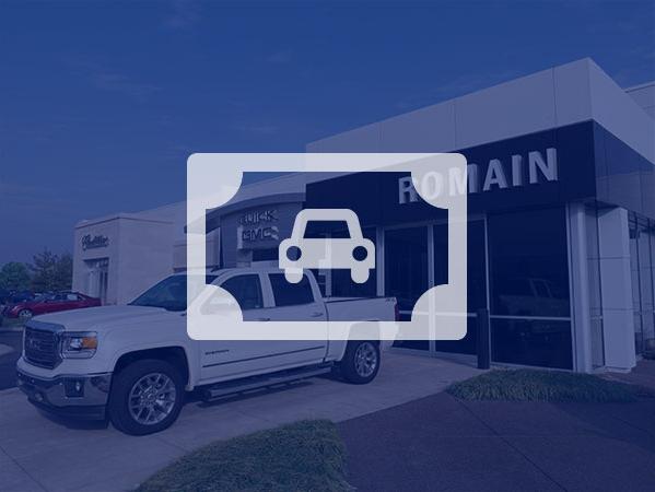 Two women looking at a tablet next to a new car. Two women looking at a tablet next to a new car.
