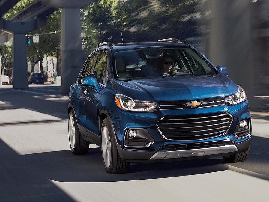 2018 Chevy Trax driving down a city street.
