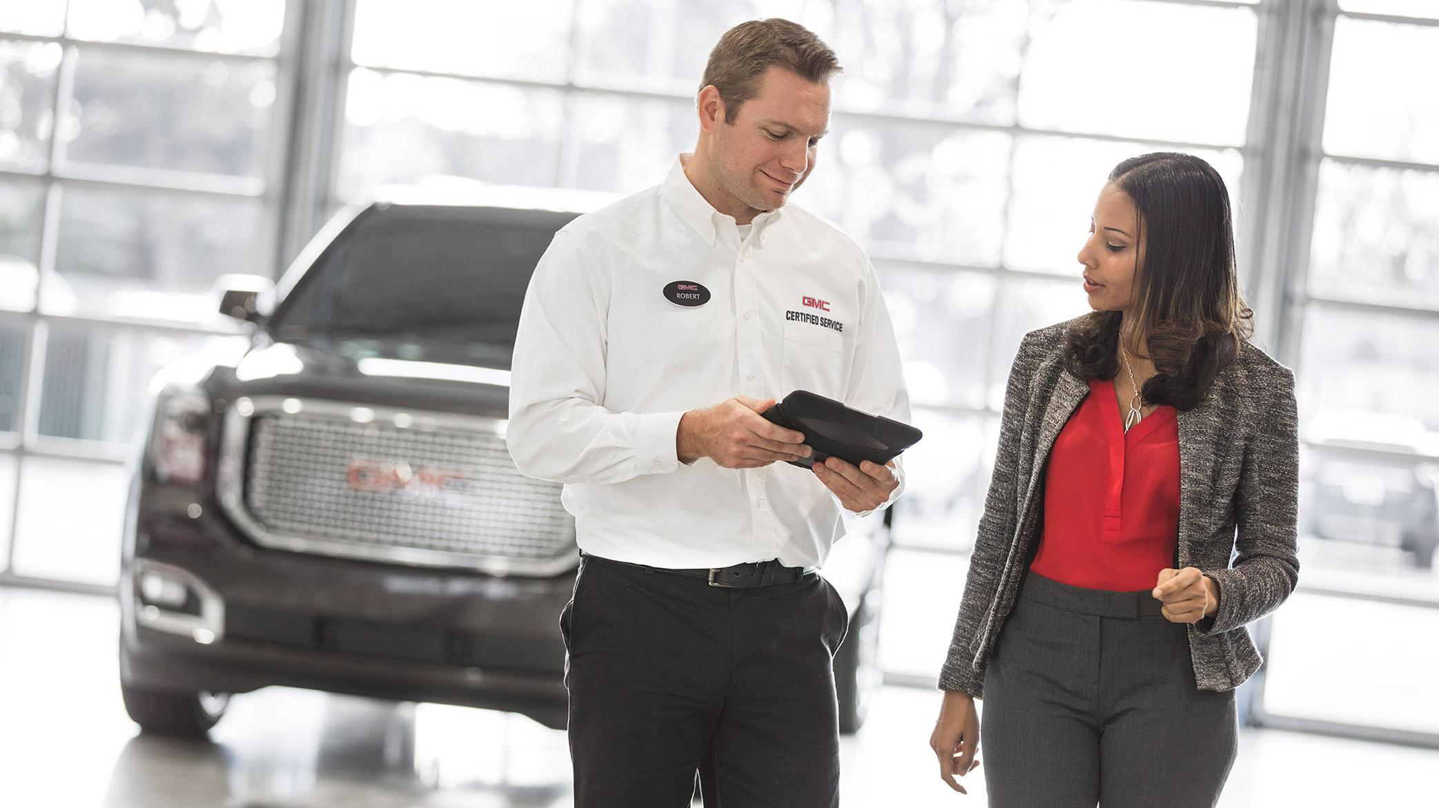 GMC Tech with Ipad talking to women GMC Tech with Ipad talking to women