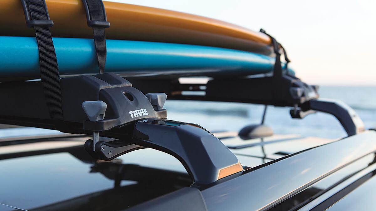 Close-up of a Thule Watersports Carrier roof rack on a vehicle. Close-up of a Thule Watersports Carrier roof rack on a vehicle.