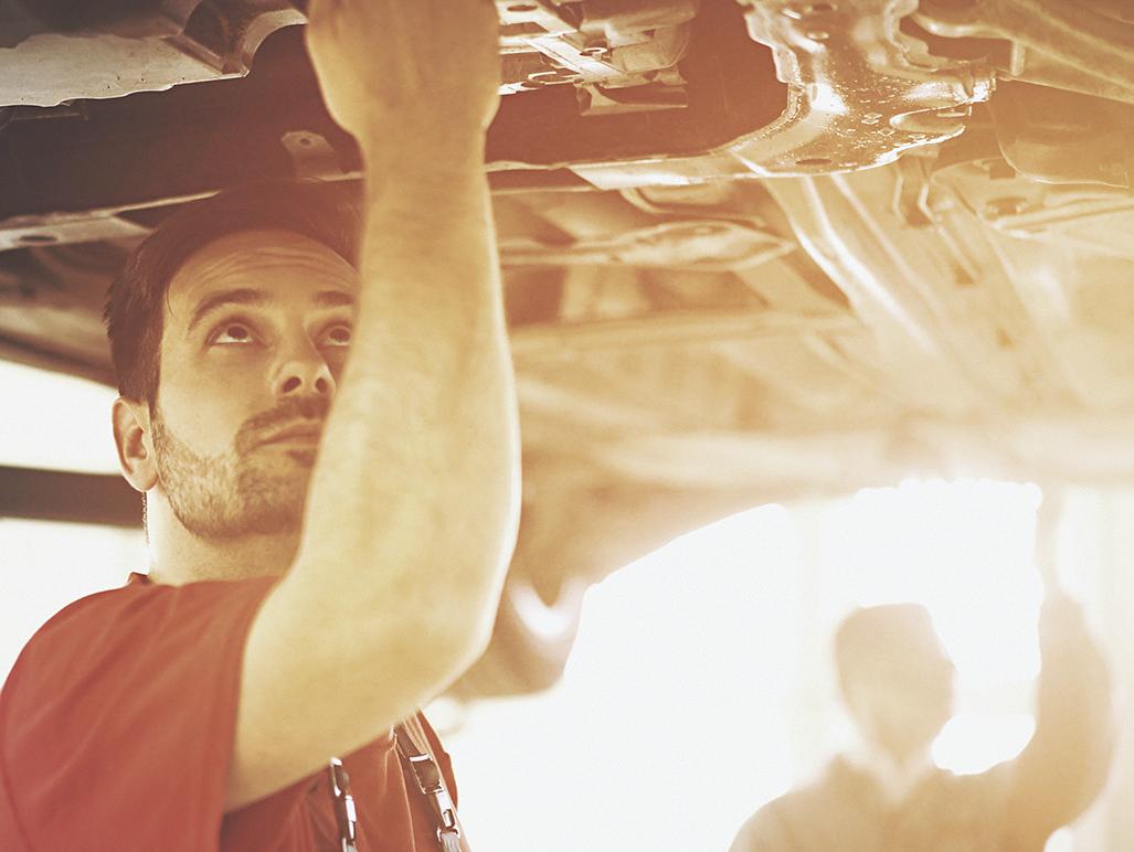 Service technician working under vehicle