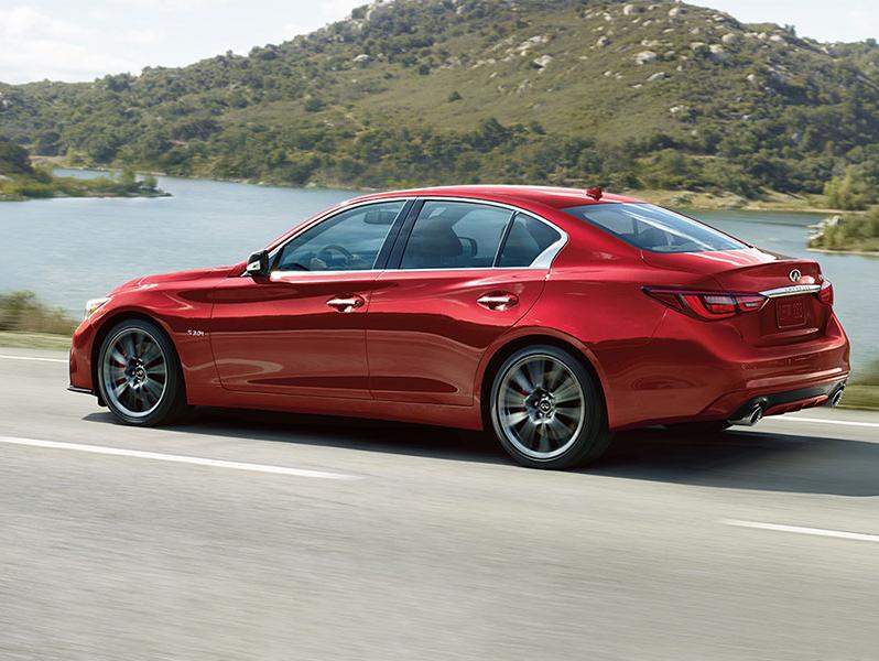 INFINITI Q50 side view on mountain road. INFINITI Q50 side view on mountain road.
