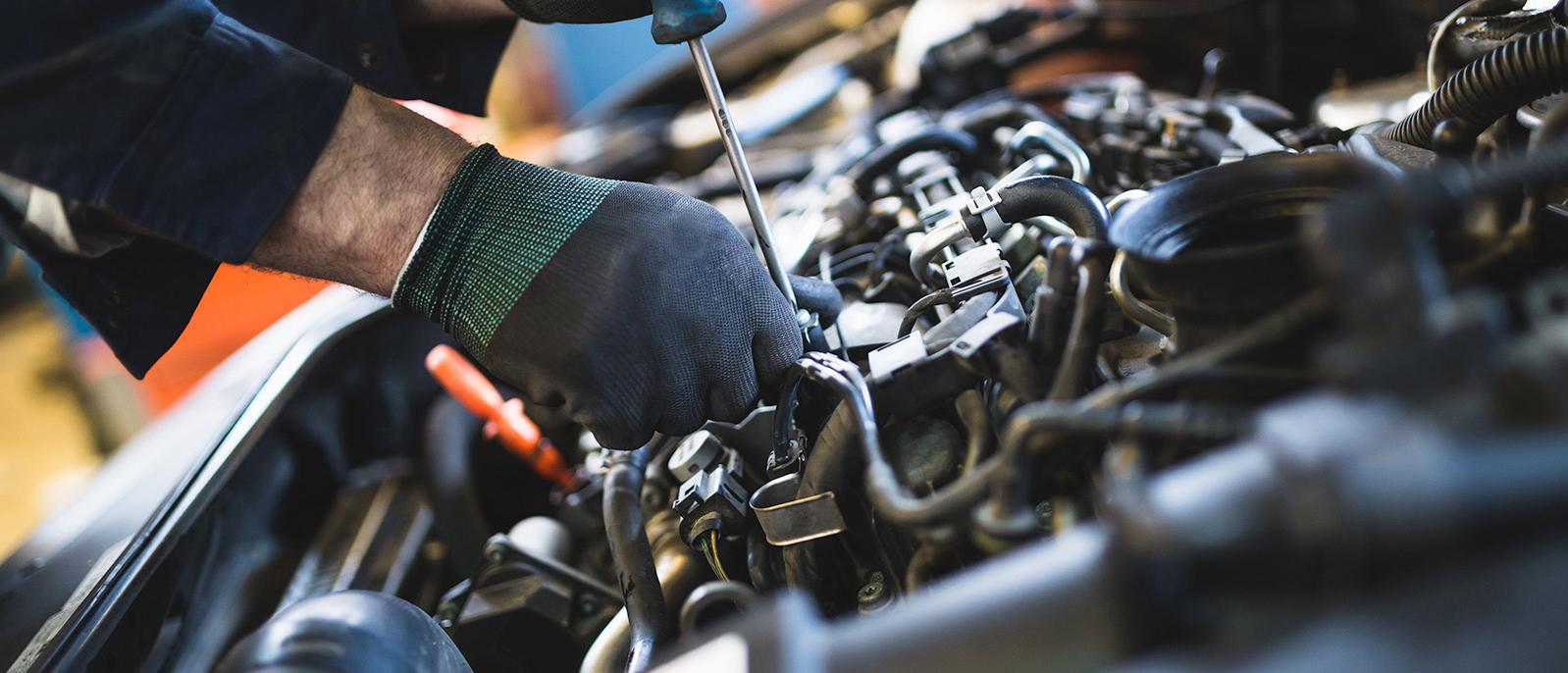 Mechanic working on automobile engine