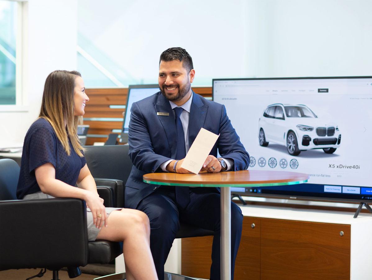 Sewell representative helping customer build their BMW