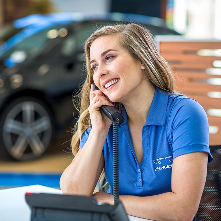 A BMW associate on the phone with a client.