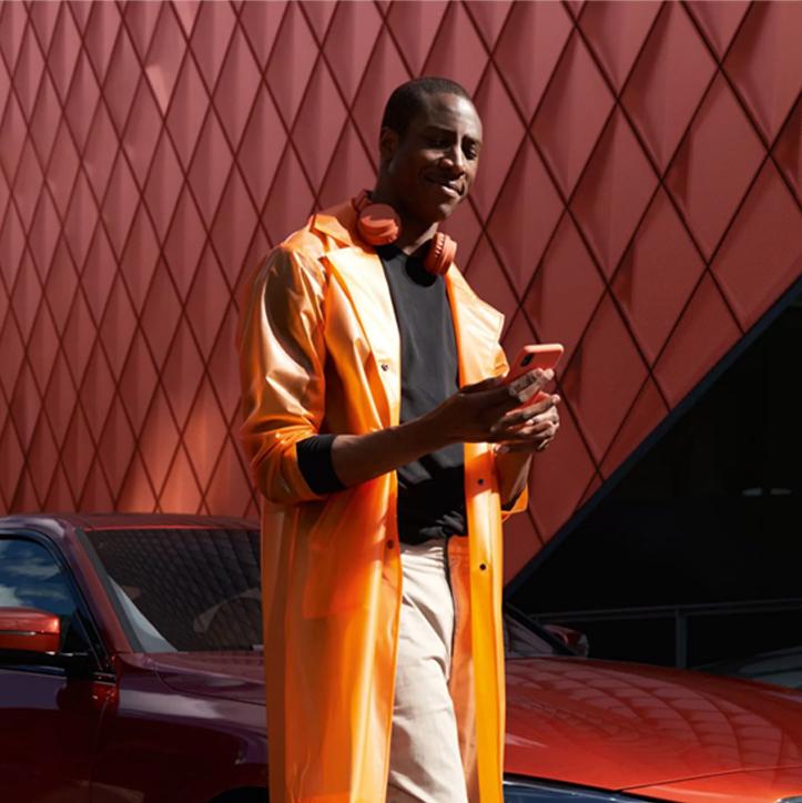 Man wearing orange coat browsing BMW app