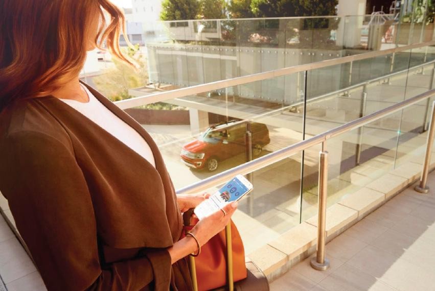 Woman looking at her phone on a sunny day.