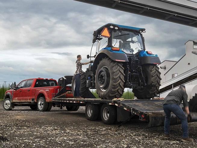 A diesel Super Duty® truck being prepared to tow a tractor