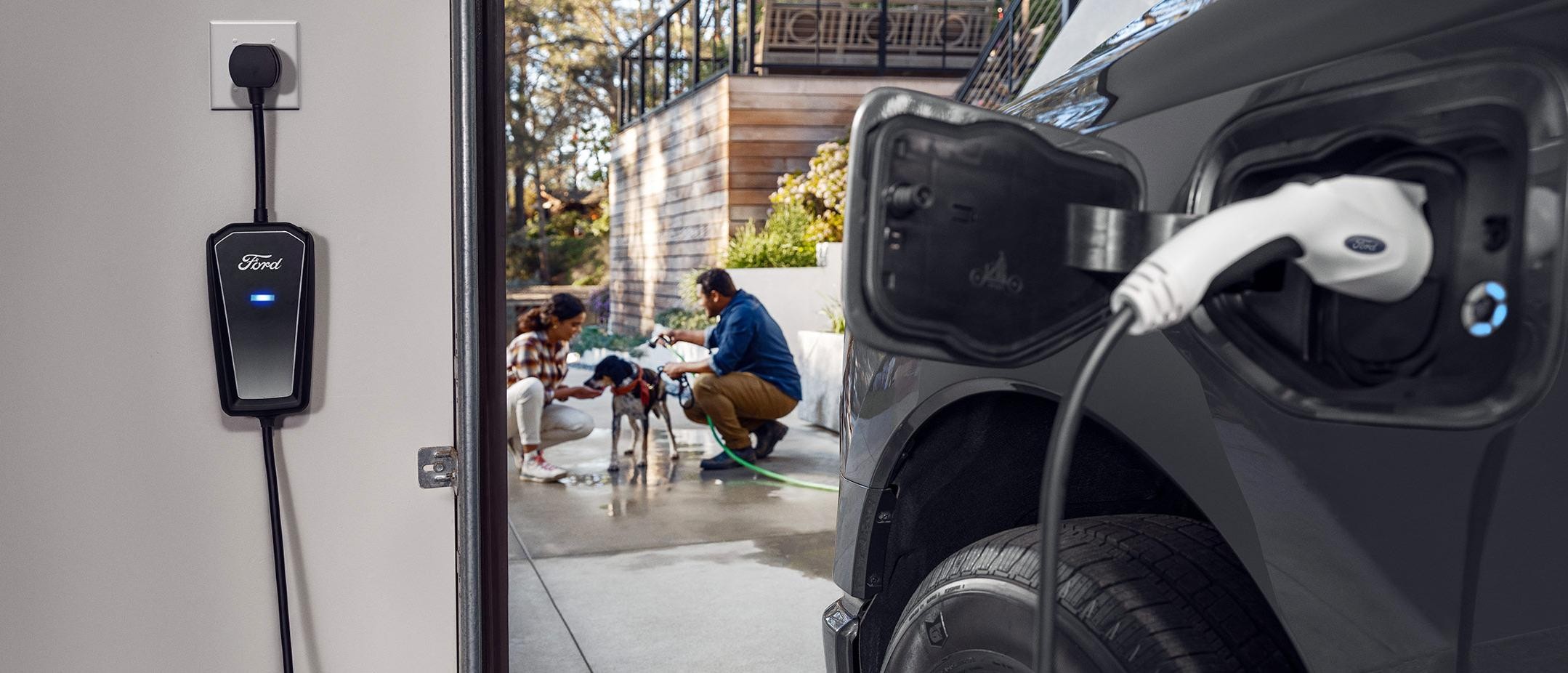 A couple is seen bathing their dog as an F-150 Lightning charges in their garage