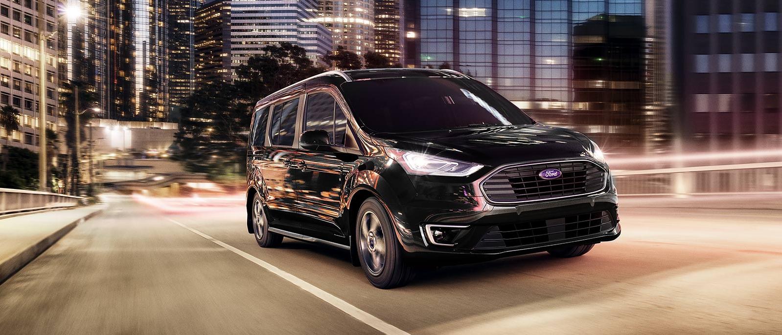 2022 black Ford Transit Connect Van is running on the road at night time. 2022 black Ford Transit Connect Van is running on the road at night time.