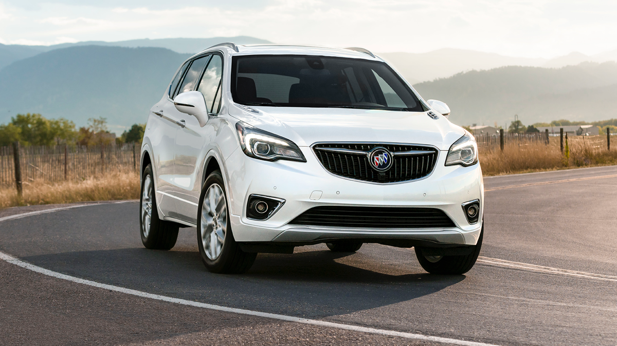 White Buick driving on a mountain road White Buick driving on a mountain road