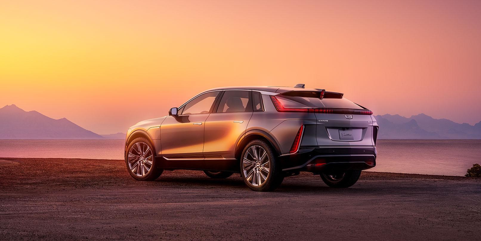 2023 Cadillac Lyriq 3/4 rear view parked on road in sunset. 