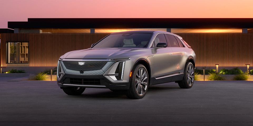 2023 Cadillac Lyriq parked in front of modern house during sunset