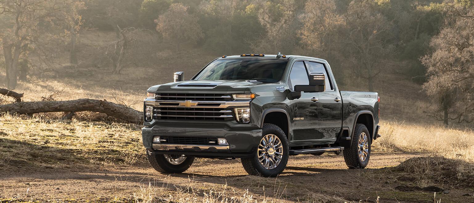 Chevrolet Silverado 3500HD parked on an unpaved road.