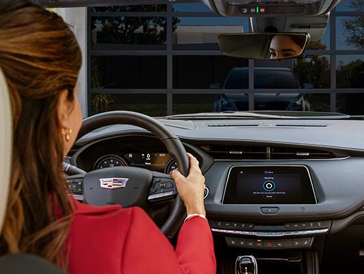 Woman in car in driveway with alexa on display screen
