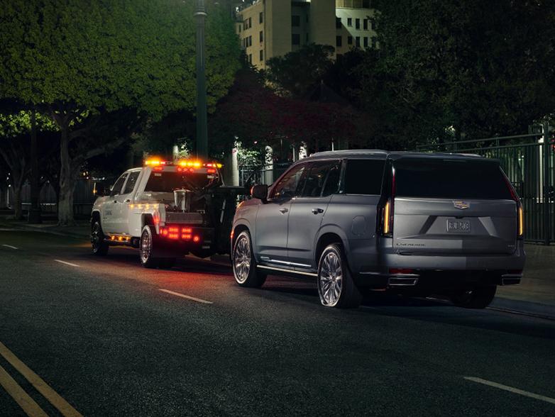 Cadilac getting towed at night time