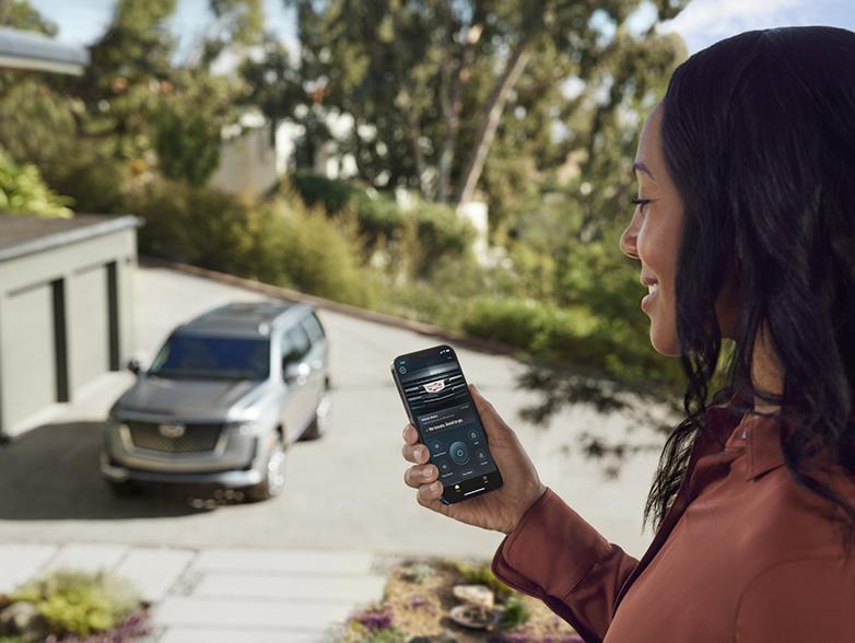 woman turning on car from phone