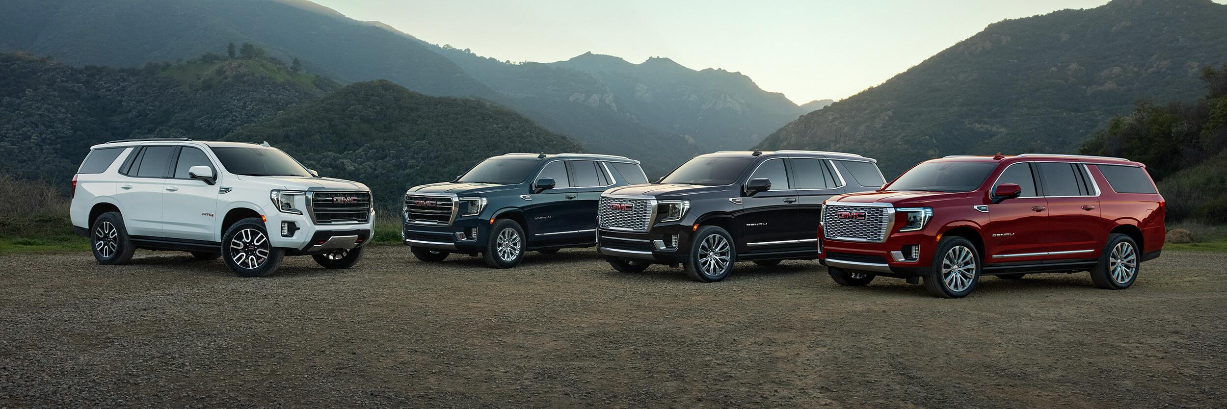 GMC Yukon and Yukon XL parked in front of mountain GMC Yukon and Yukon XL parked in front of mountain