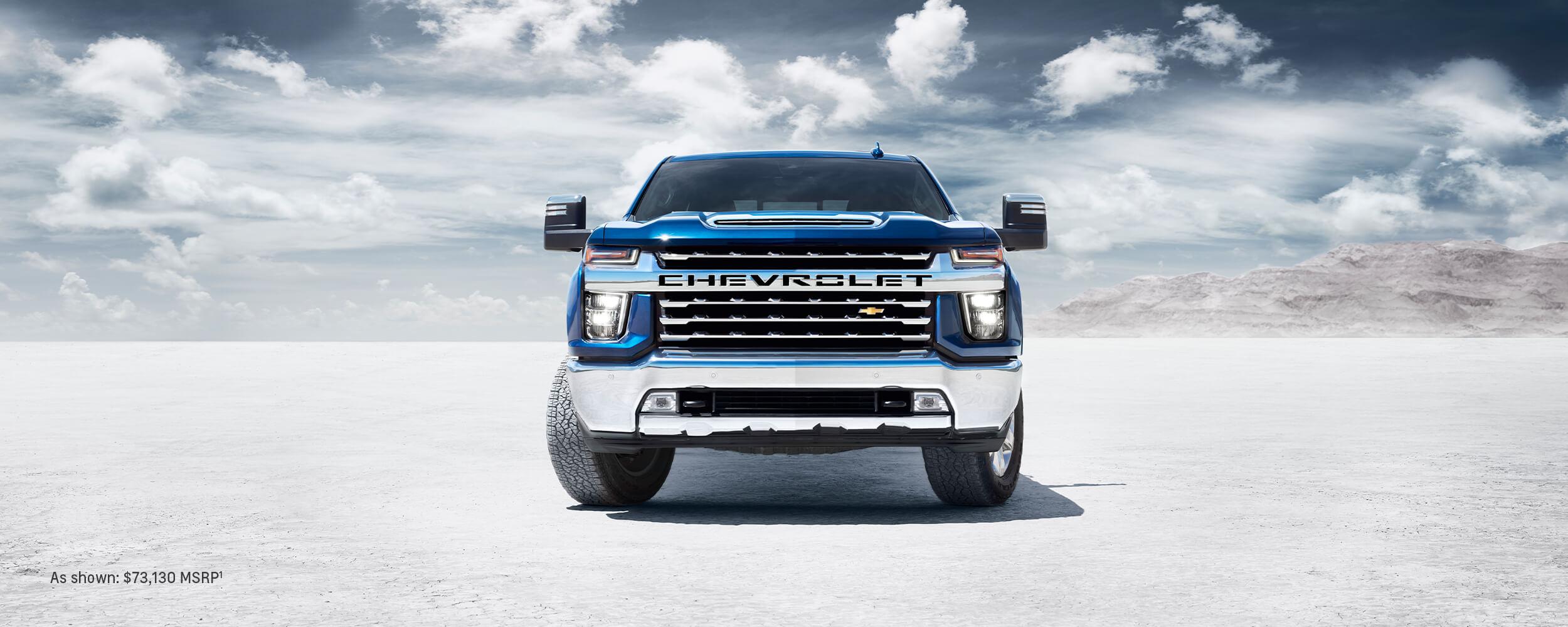 A blue Chevy Silverado HD parked in open space A blue Chevy Silverado HD parked in open space