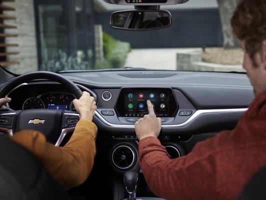 Person pushing button on display with apps Person pushing button on display with apps