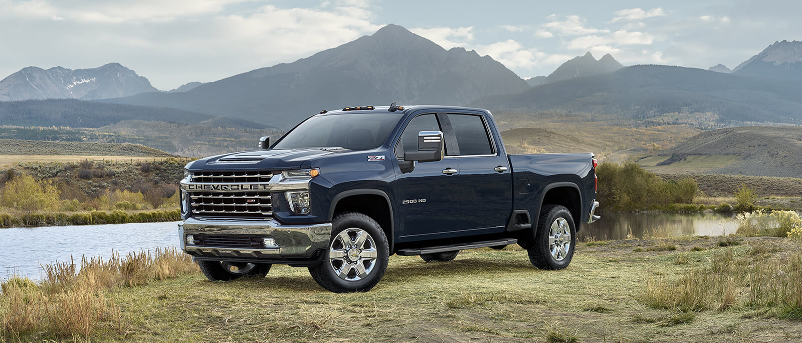 Chevrolet Silverado 2500HD parked near a river.