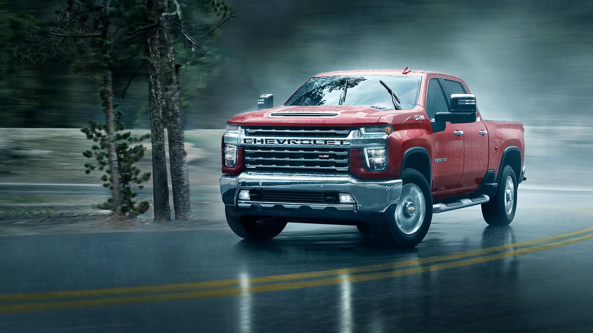2021 Chevy Silverado 2500HD driving through a rainy day.