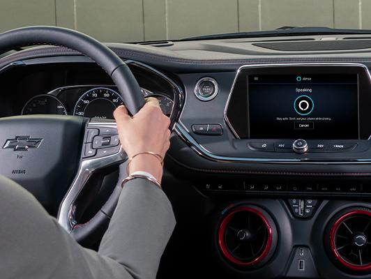 Woman driving with alexa on display Woman driving with alexa on display